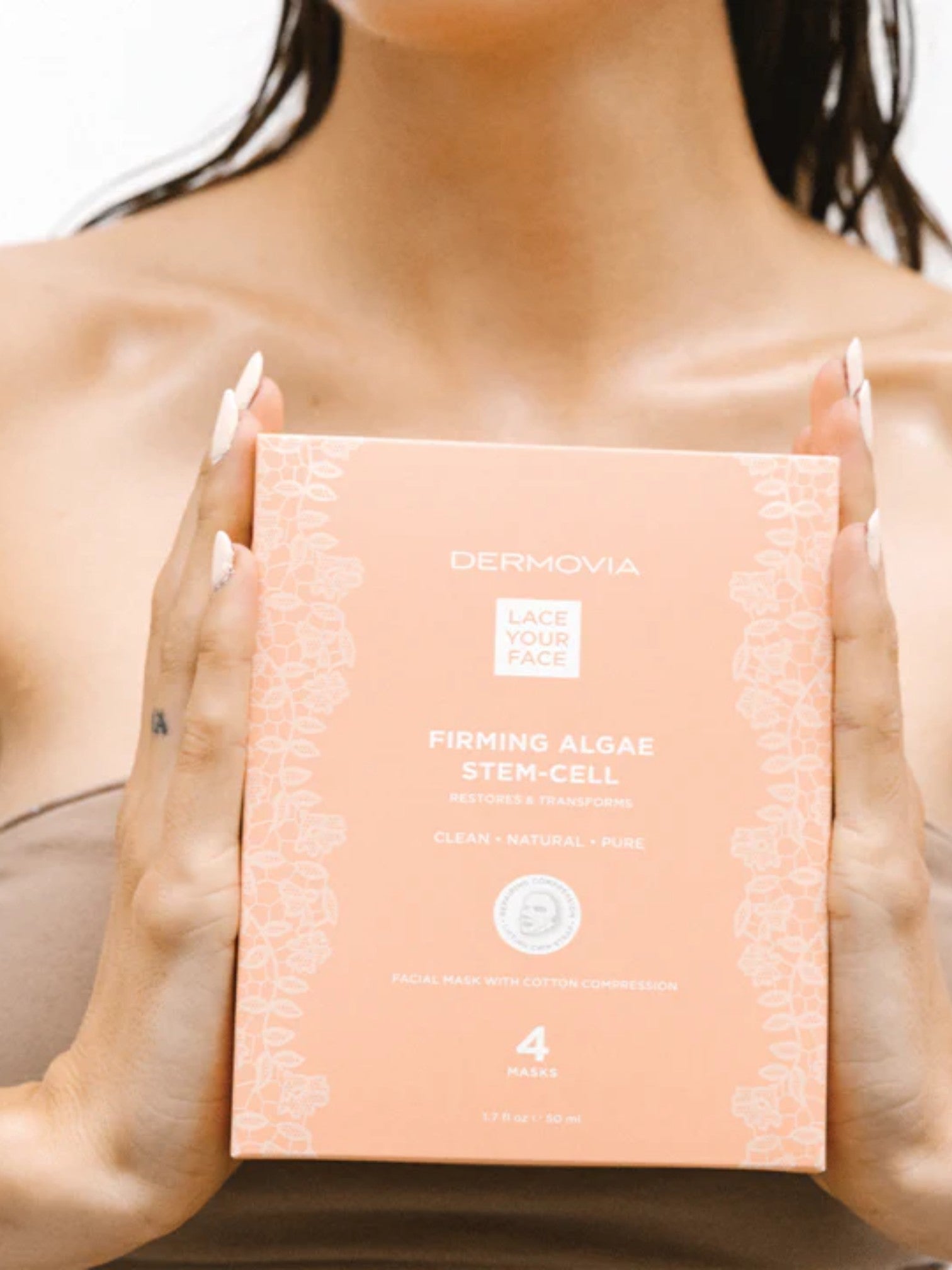 Person holding a Dermovia Firming Algae Stem Cell product box.