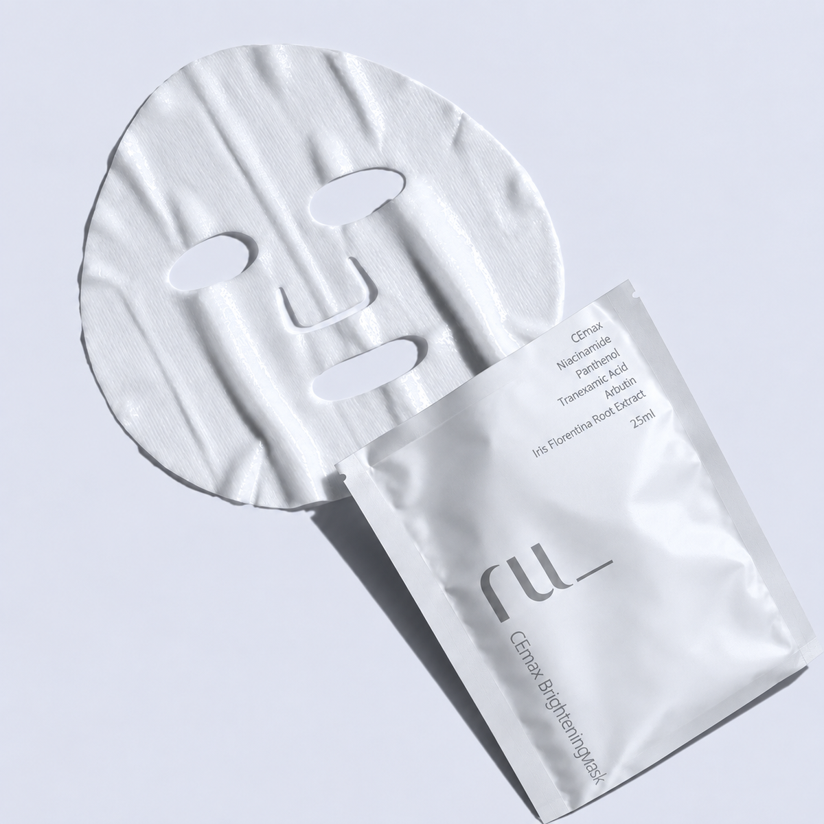 Unfolded RU CEmax sheet mask beside its white 25 ml sachet.