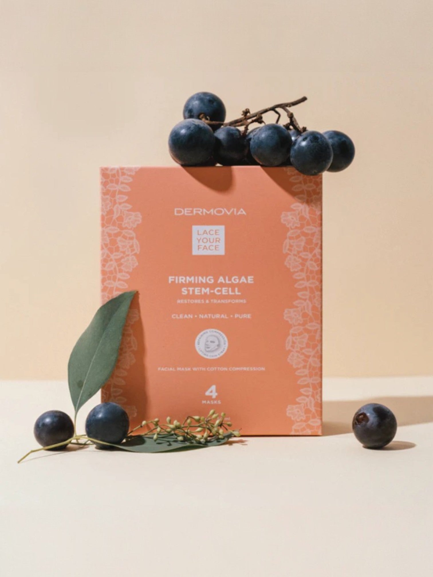 Dermovia facial mask packaging with blueberries and green leaves on a beige background