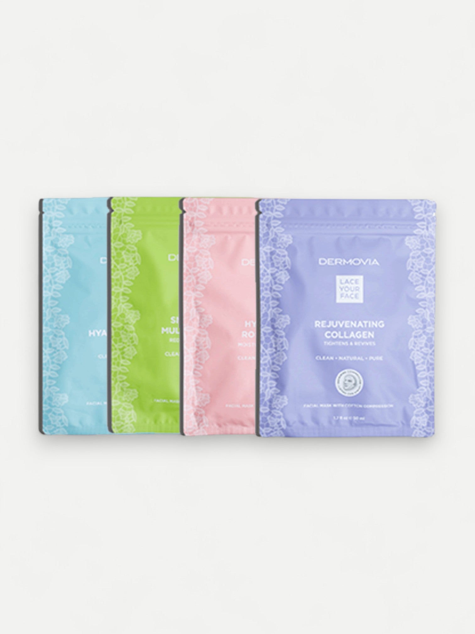 Four skincare Dermovia mask packets in different colors on a white background